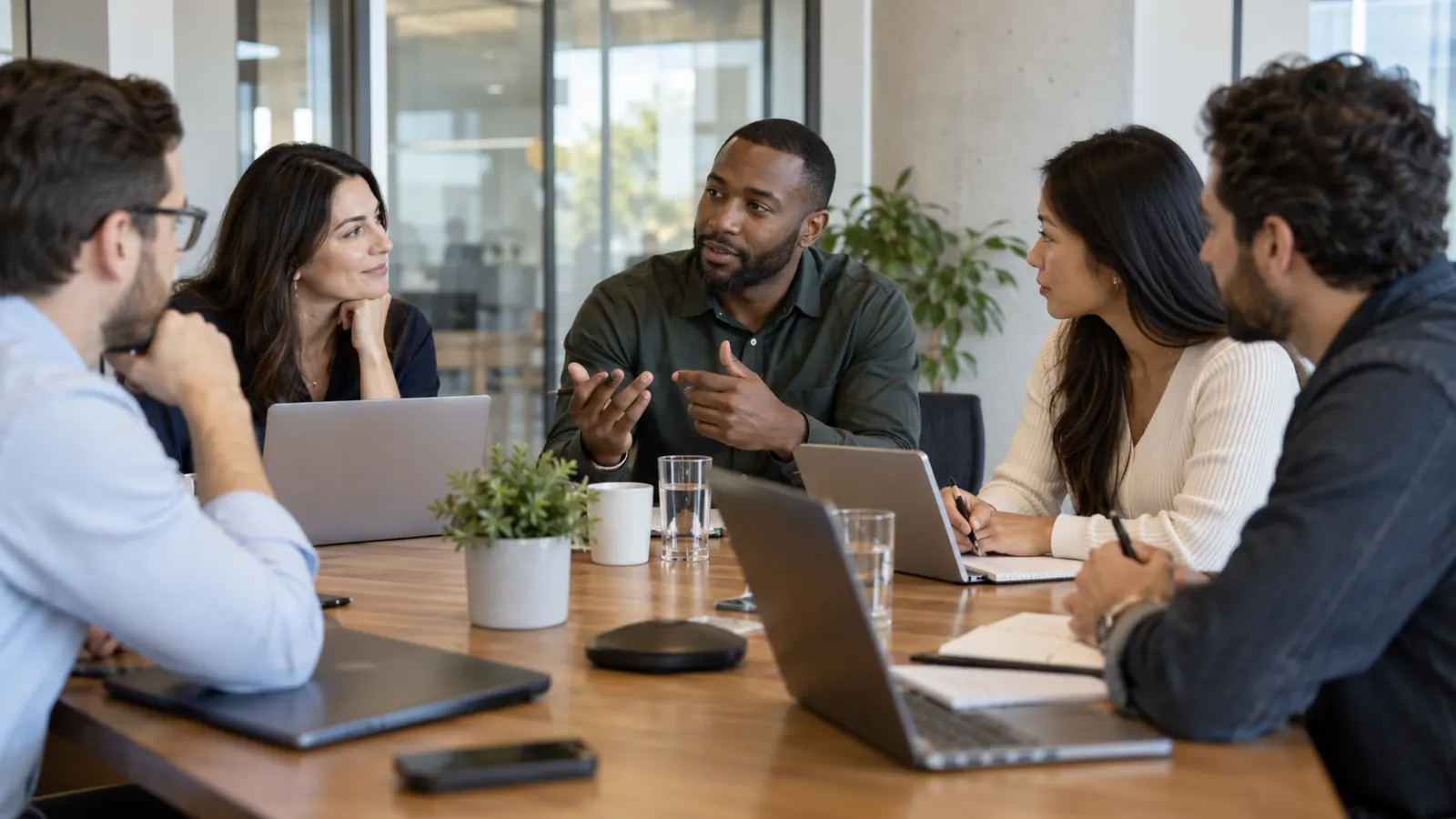 Professional team using respectful turn-taking during a workplace meeting